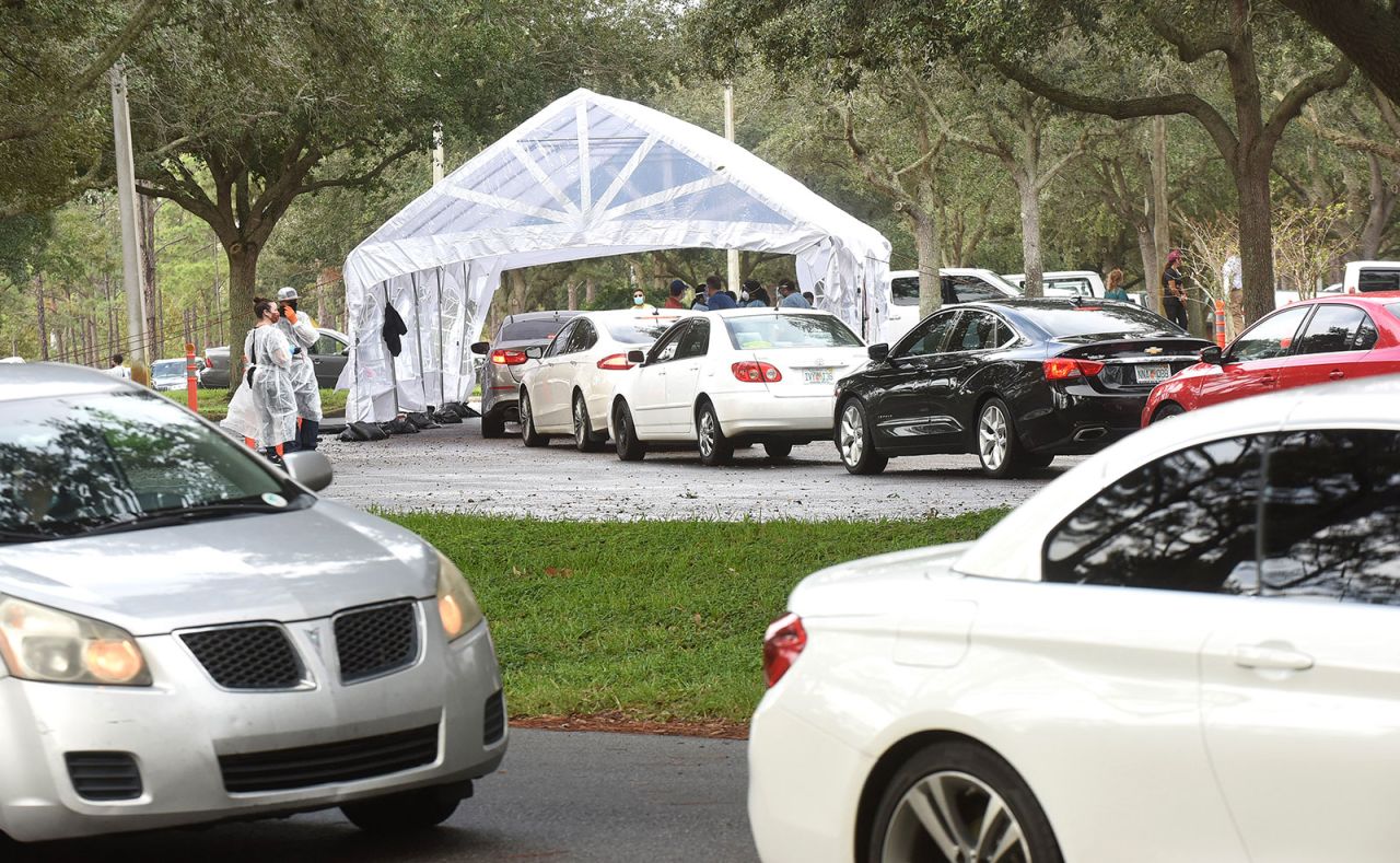 People in cars line up to receive Covid-19 tests at a drive through testing site in Orlando, Florida, on November 9.