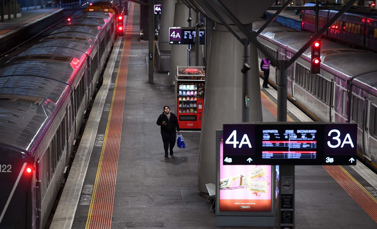 A passenger walks along a platform during rush hour at Melbourne's Southern Cross station on June 30. The Australian state of Victoria has reintroduced lockdown measures on 10 Melbourne suburbs following a recent spike in coronavirus cases.