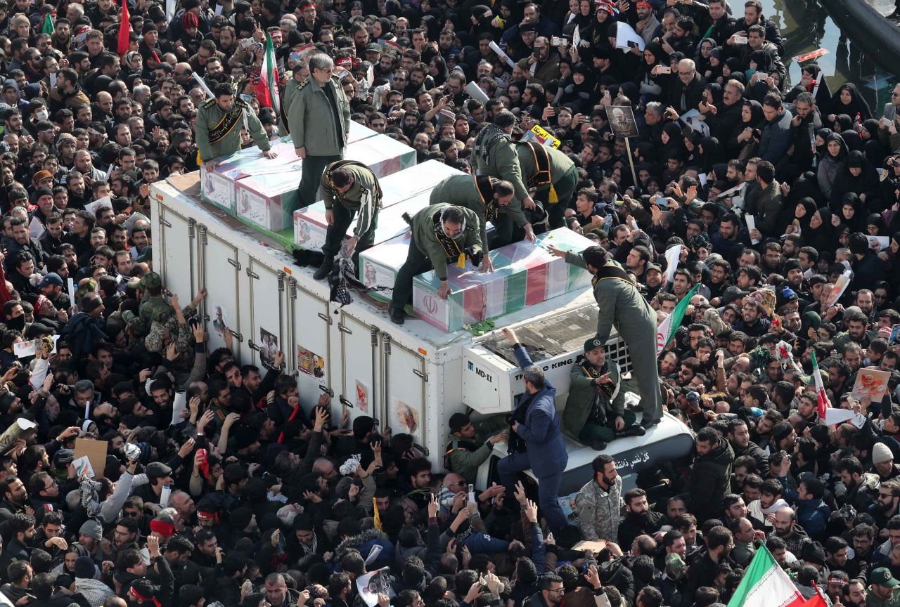 Iranians surround the coffins of Soleimani and others killed in a US airstrike in Baghdad on Friday. 