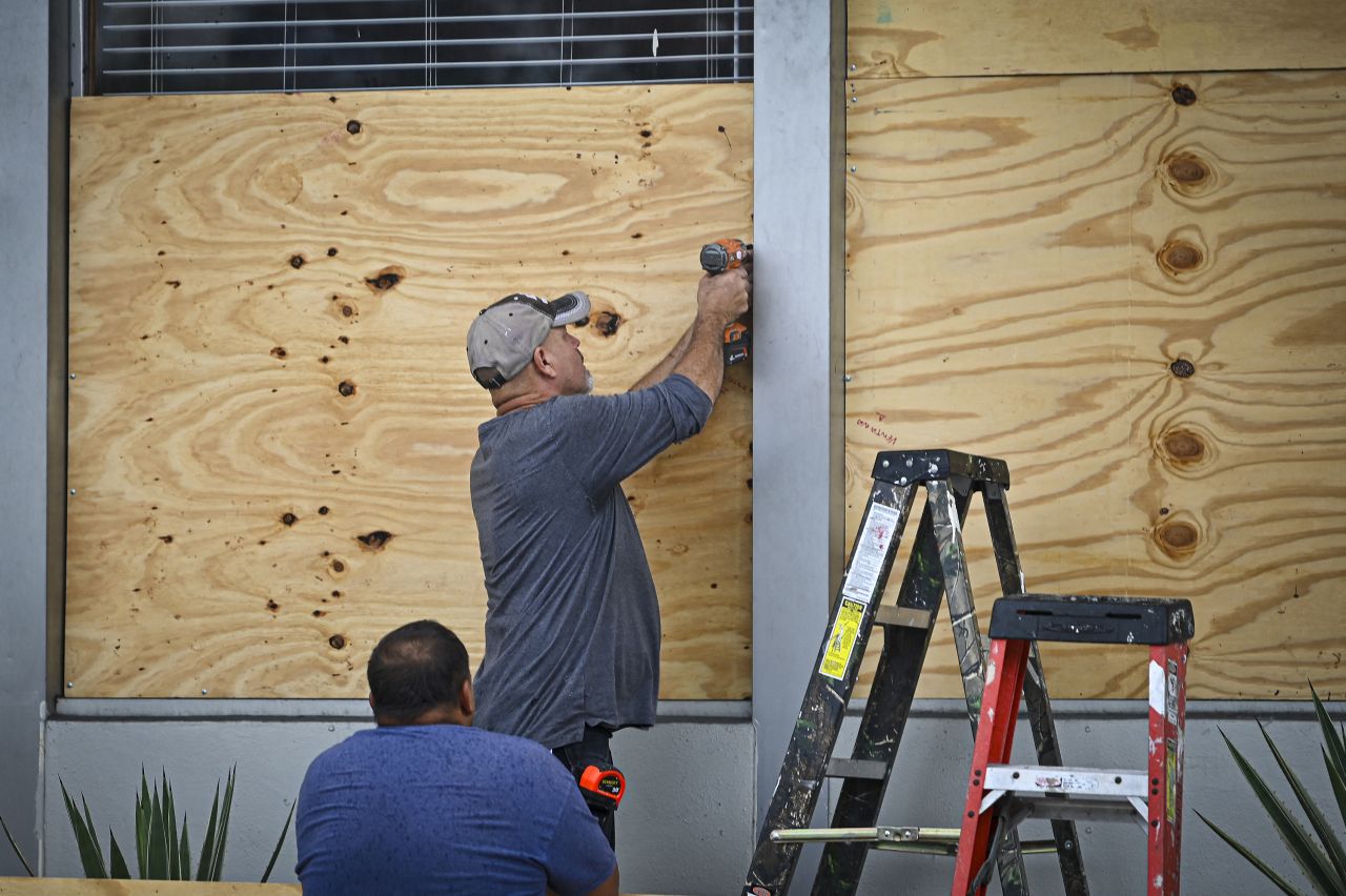 People board up a window in Tampa, Florida, on August 29.