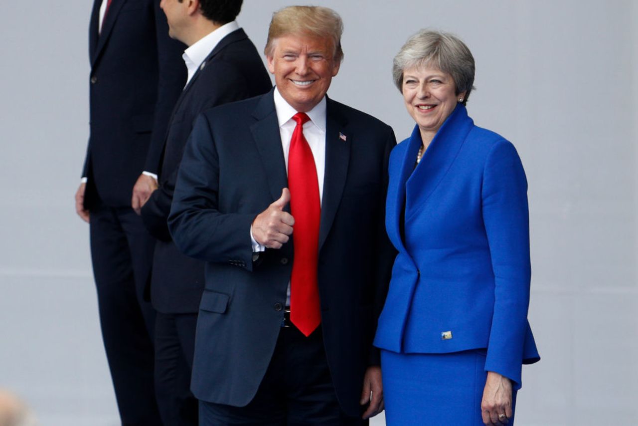 US President Donald Trump (L) poses with Britain's Prime Minister Theresa May during a family photo ahead of the opening ceremony of the NATO in Brussels, on July 11, 2018.