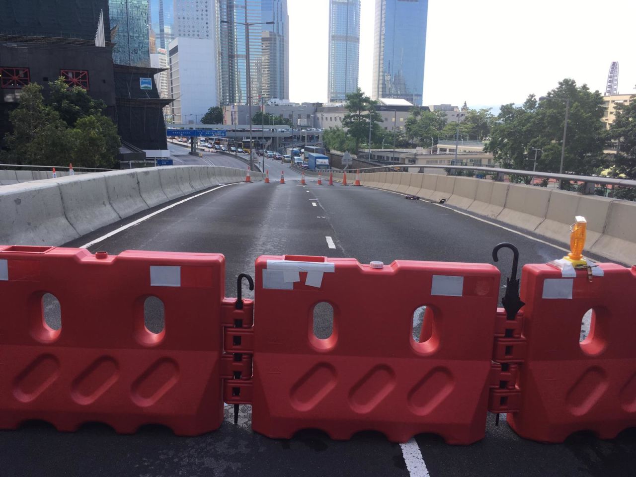 Protesters on Harcourt Road are building road blocks using umbrellas as makeshift joiners.