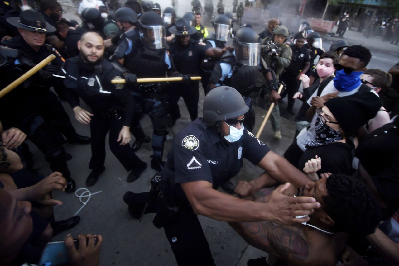 Police officers and protesters clash near CNN center in Atlanta, Georgia, on Friday, May 29. 