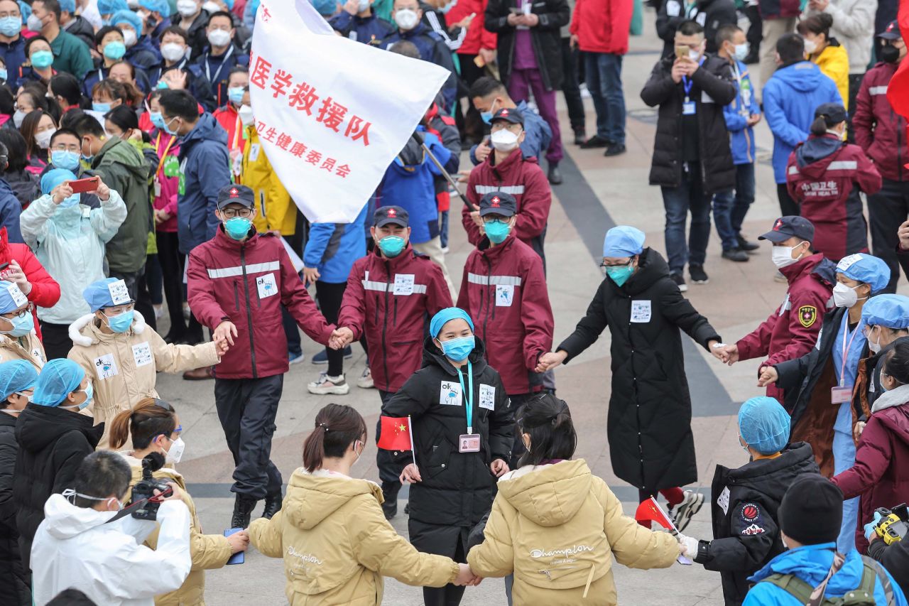 Medical staff celebrate after all coronavirus patients were discharged from a temporary hospital in Wuhan on Monday.