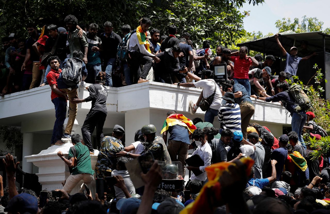 Protesters climb the front gate of?Sri?Lanka's Prime Minister Ranil Wickremesinghe's office during a protest in Colombo,?Sri?Lanka, on?July 13.