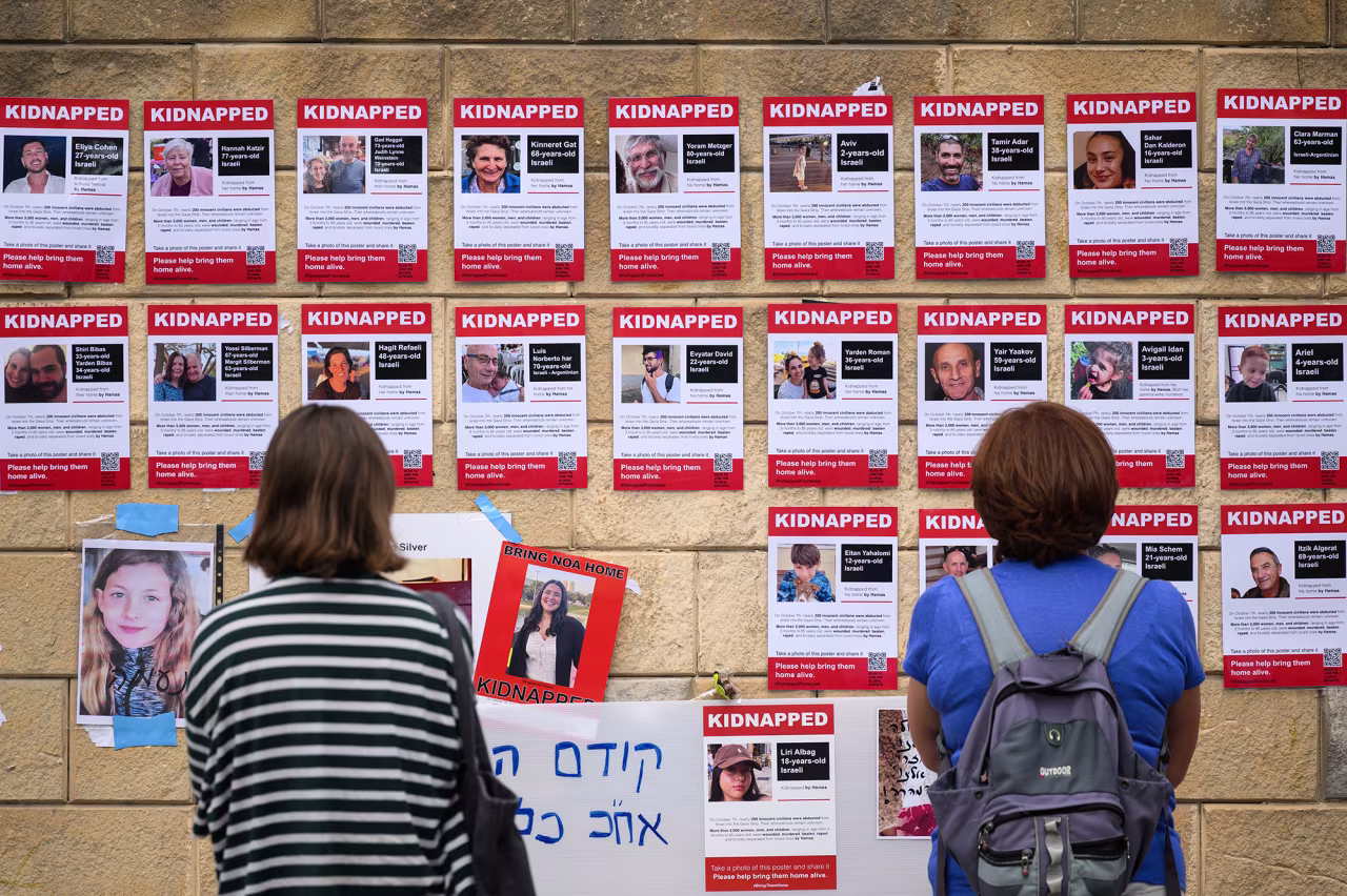 Photographs of some of those taken hostage by Hamas during their recent attacks are seen on October 18, in Tel Aviv, Israel.