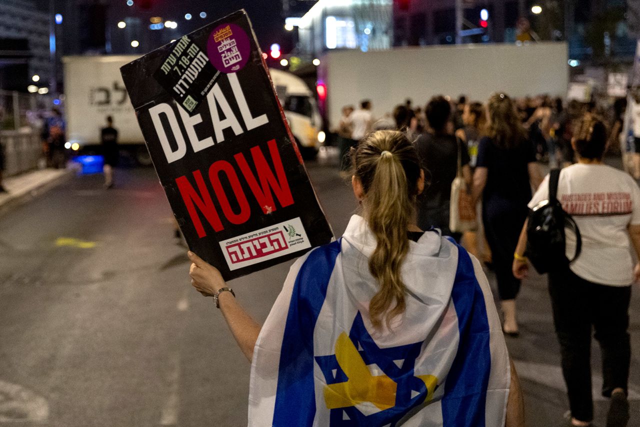 A protesters holds a sign calling for a hostage deal during a demonstration against Israeli Prime Minister Benjamin Netanyahu's government on  in Tel Aviv, Israel, on August 24.