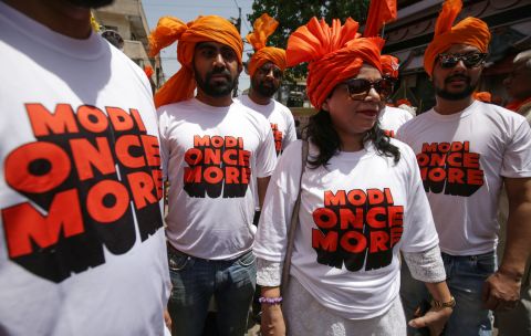 Supporters of the Bharatiya Janata Party (BJP) wear T-shirts supporting Indian Prime Minister Narendra Modi in Bhopal on April 23, 2019. 