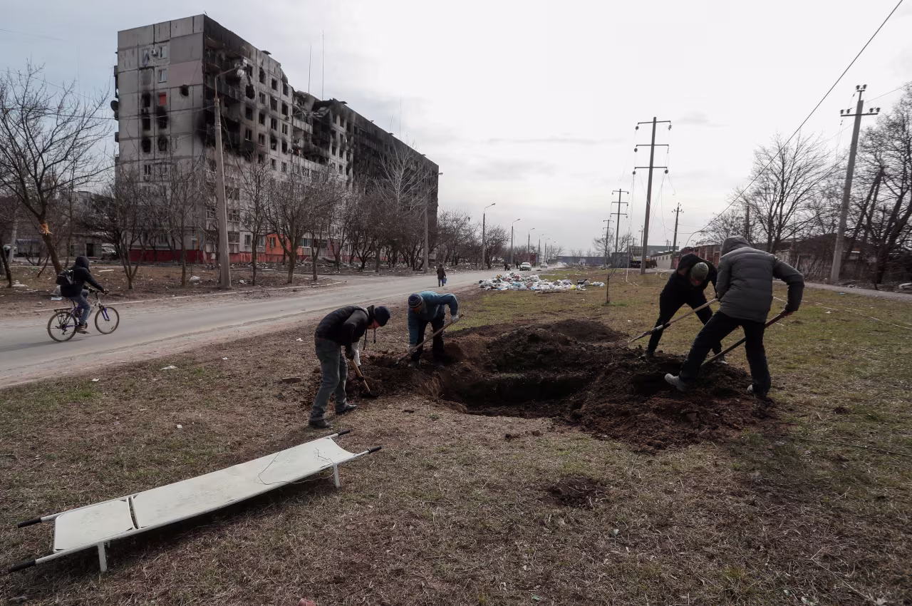 People dig a grave for victims killed during Ukraine-Russia conflict, in a the port city of Mariupol, Ukraine on March 20. 