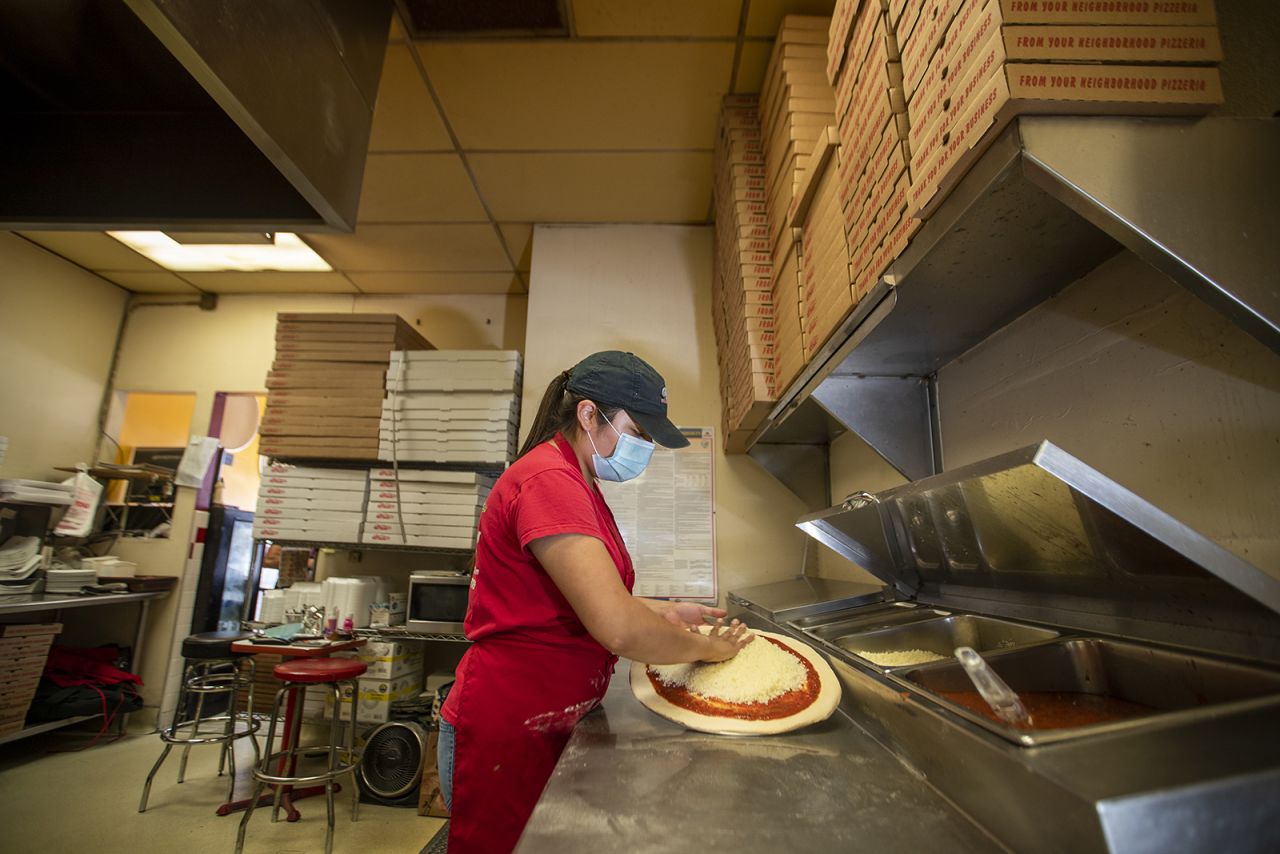 Jocelyn Campos, 28, manager of Big Berthas Pizza, makes pizza at her family's restaurant near Disneyland on Wednesday, September 30, in Anaheim, California.