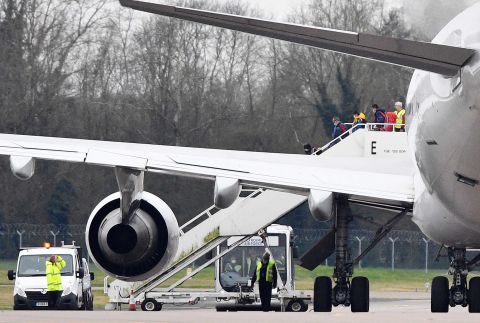 Some of the 83 Britons and 27 foreign nationals who were evacuated from Wuhan disembark a plane at RAF Brize Norton in England on Friday.