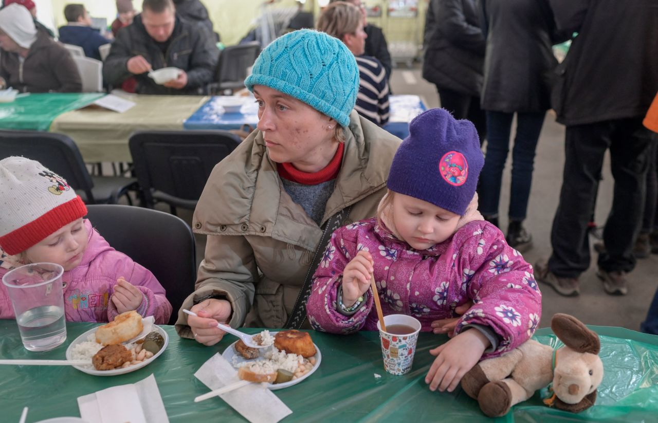 A woman and children eat a meal after their arrival at at a displaced persons' hub in Zaporizhzhia, Ukraine, on April 5.