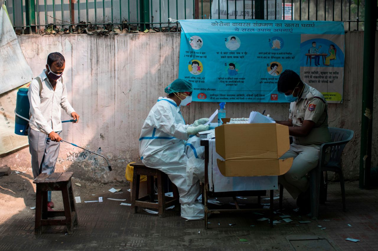 A medical worker along with a policeman sort out swab samples collected for Rapid Antigen Tests for Covid-19 at a dispensary in New Delhi on November 10.