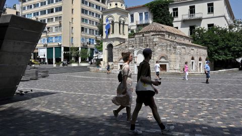 People walk at central Athens square on June 24.
