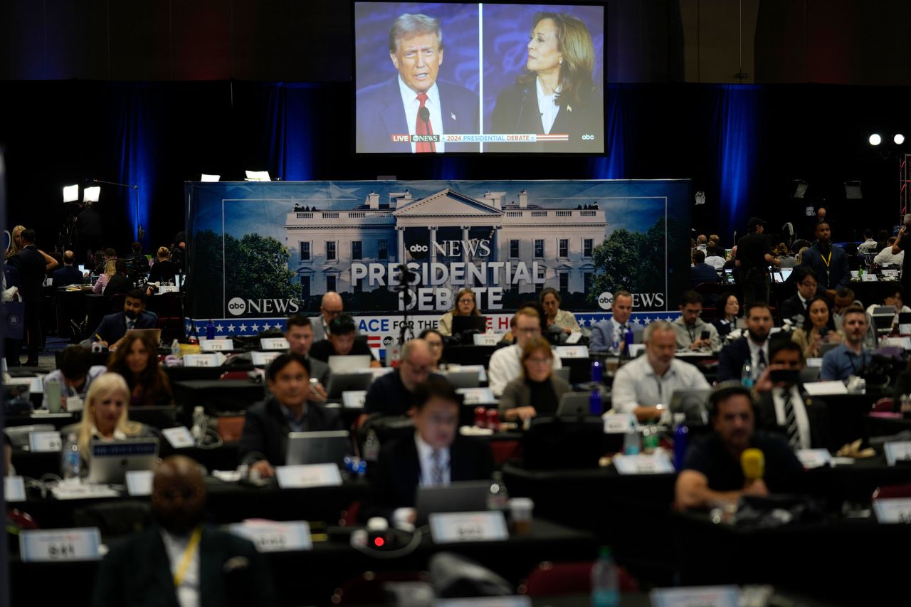 A presidential debate between former President Donald Trump, on screen at left, and Vice President Kamala Harris, right, is seen from the spin room on Tuesday in Philadelphia.