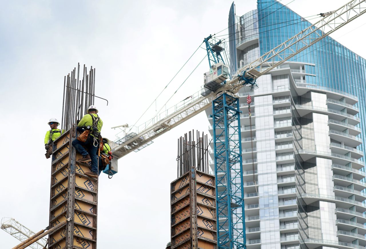 Construction workers build a residential high rise on October 2 in Miami, Florida.