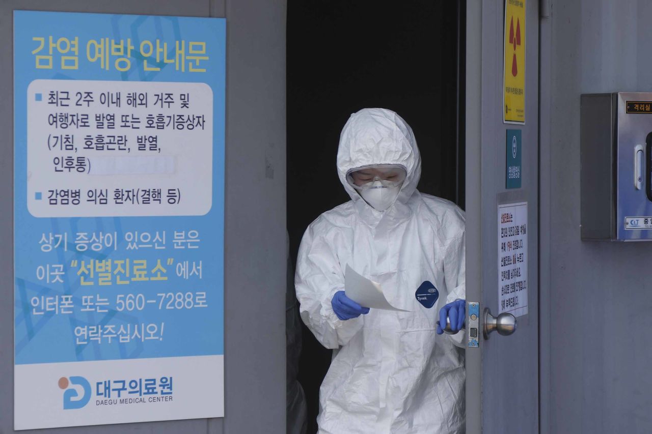 A member of staff is seen on Thursday at a medical center in the city of Daegu, South Korea, where new cases of the coronavirus have been reported.