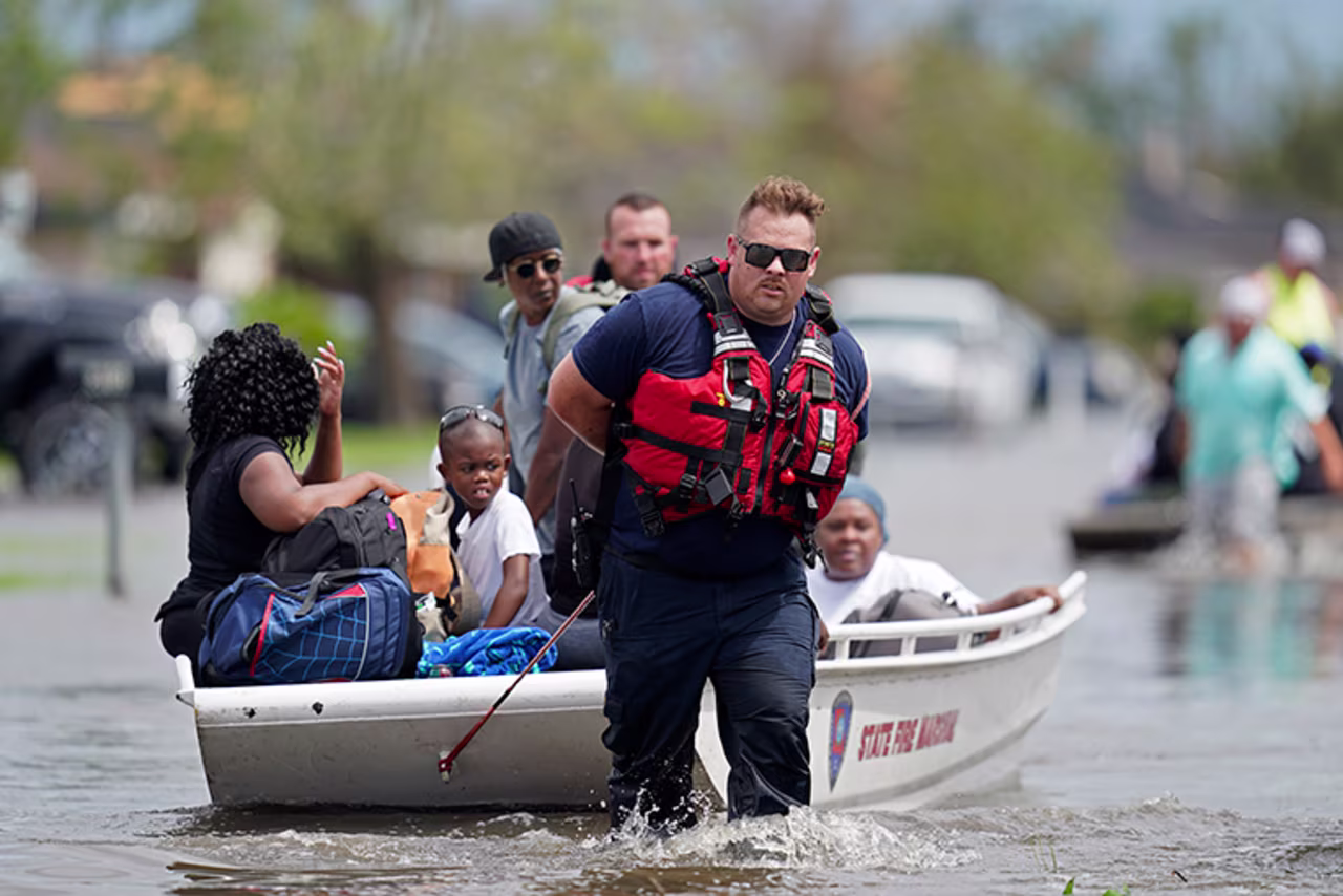 Members of the Louisiana State Fire Marshal's office rescue people from floodwaters in the aftermath of Hurricane Ida in New Orleans, Louisiana, Monday, August 30. 