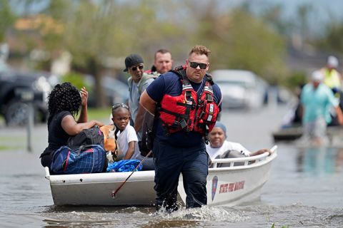 Members of the Louisiana State Fire Marshal's office rescue people from floodwaters in the aftermath of Hurricane Ida in New Orleans, Louisiana, Monday, August 30. 