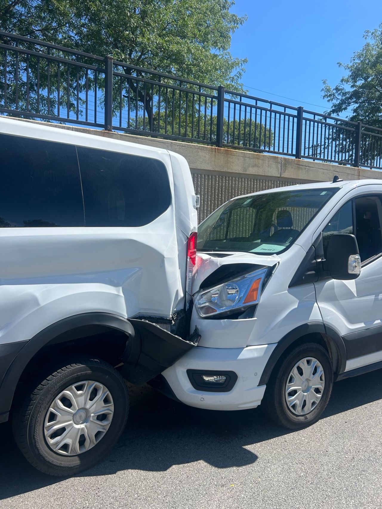 This image shows damage to two of the vans in the motorcade.