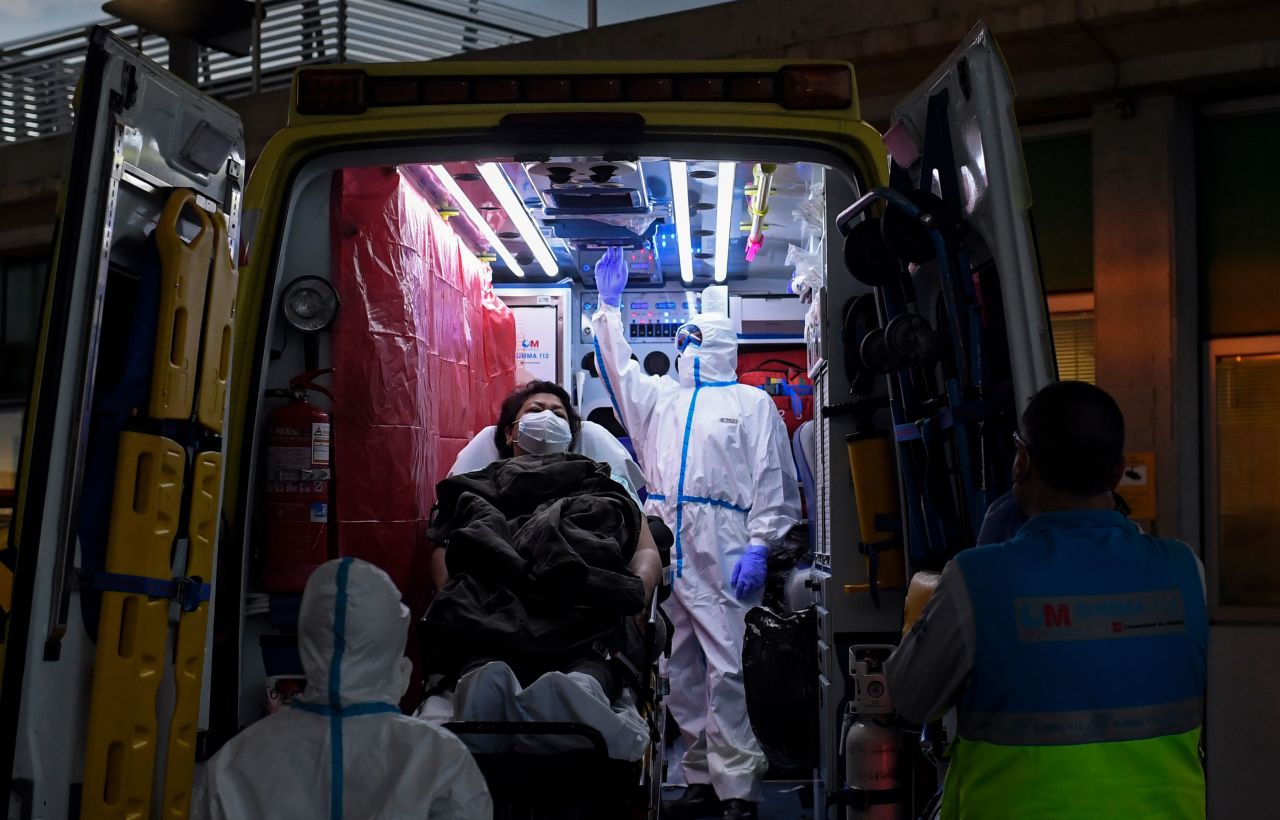 Healthcare workers of the Medical Emergency Services of Madrid transfer a suspected Covid-19 patient from her home to the hospital in Madrid on April 19.