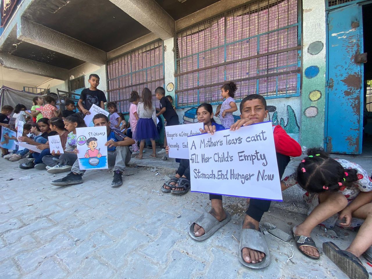 The kids held Arabic and English slogans at the demonstration on Tuesday, calling for an end to widespread hunger in northern Gaza. 