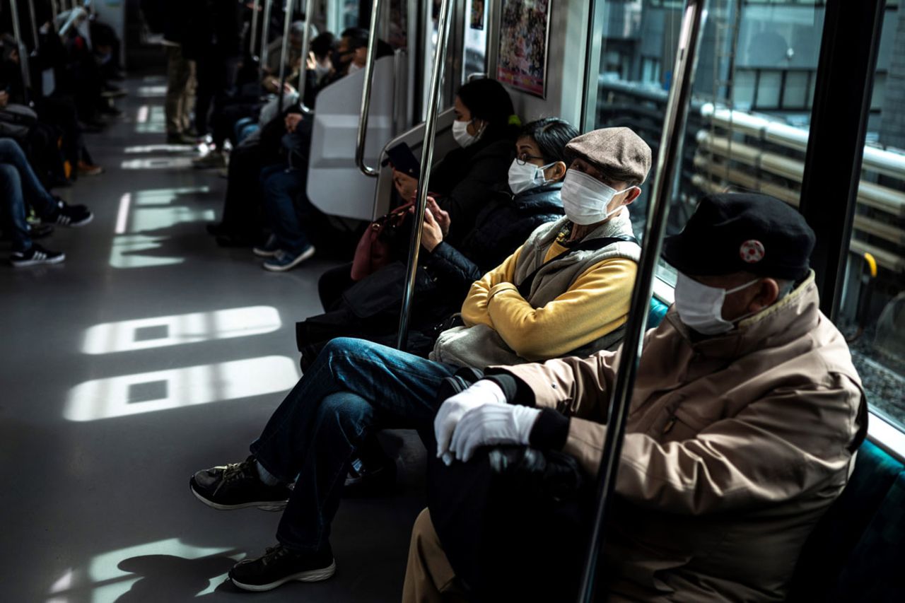 People commute on a train in Tokyo, Japan on March 5 as officials extended a coronavirus state of emergency in the Tokyo area.