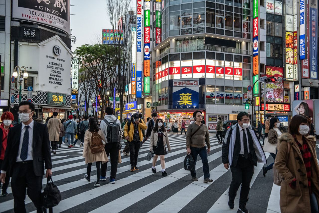 People cross a road near the Kabuki-cho district of Tokyo, an area that has seen a disproportionate number of coronavirus cases, on April 6, in Tokyo, Japan. 