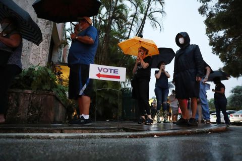 People wait in line to vote in Coral Gables, Florida, on Monday, October 19. 
