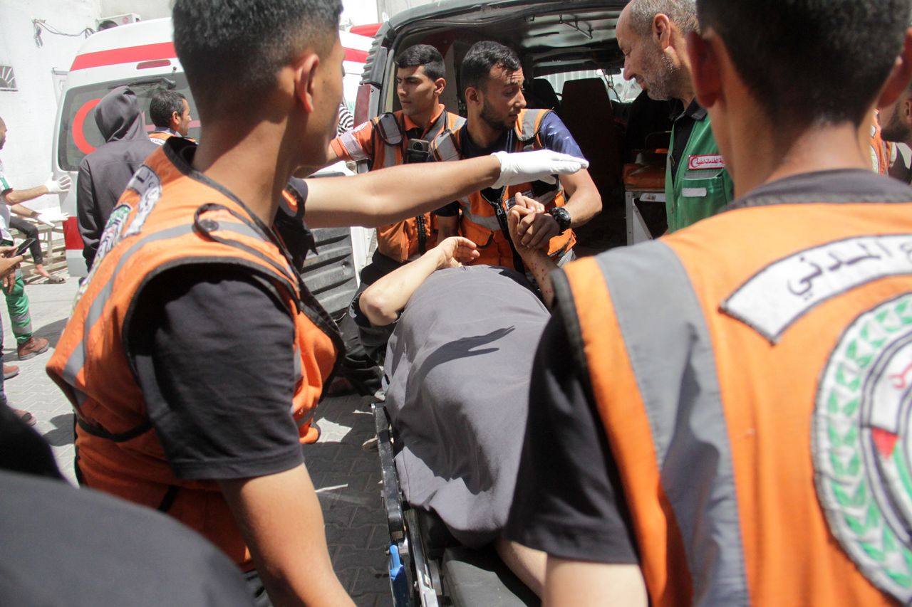 Palestinians injured in Israeli airstrikes are brought Kamal Adwan Hospital in Beit Lahia, Gaza, on May 13.