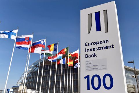 Flags are seen behind the sign of the European Investment Bank in Luxembourg in 2017.