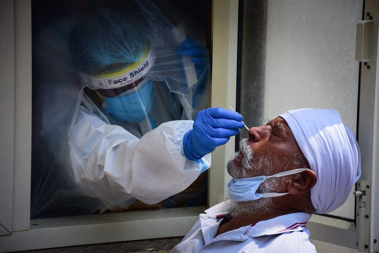 A health worker collects a swab sample from a man to test for Covid-19 at Nehru Homoeopathic Medical College and Hospital, Defence Colony in New Delhi, on September 9.