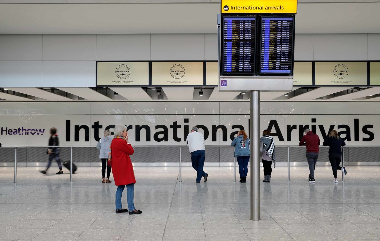 People wait for passengers at the International Arrivals hall in Heathrow Airport, in London, England, on March 17.