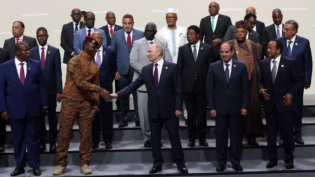 Russian President Vladimir Putin shakes hands with President of Burkina Faso Ibrahim Traore during a group photo with delegation's leaders of the Second Summit Economic And Humanitarian Forum Russia Africa, on July 28, 2023, in Saint Petersburg, Russia.