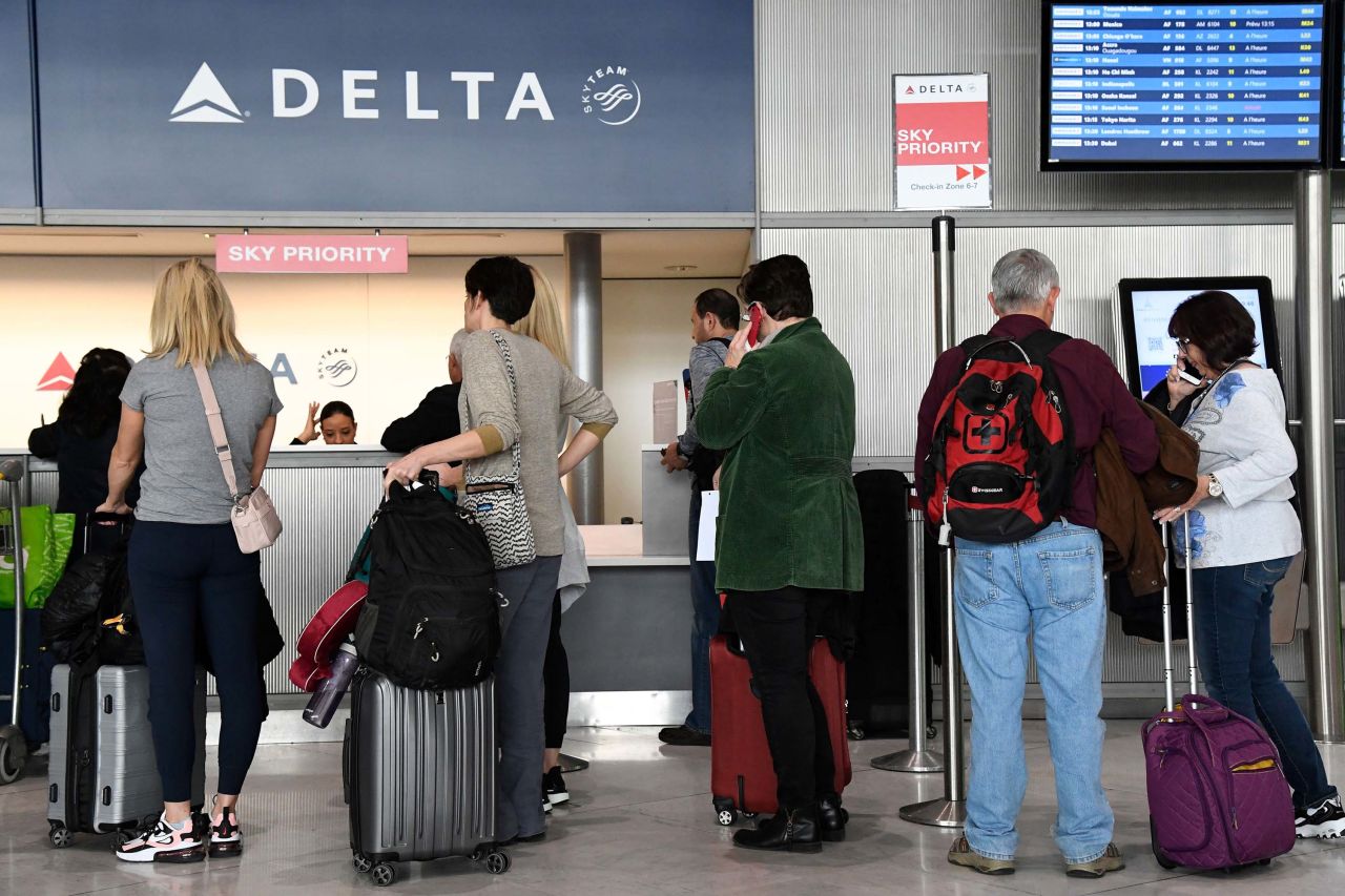 Passengers line up at a Delta Airlines desk at Paris-Charles-de-Gaulle airport in France on Thursday.