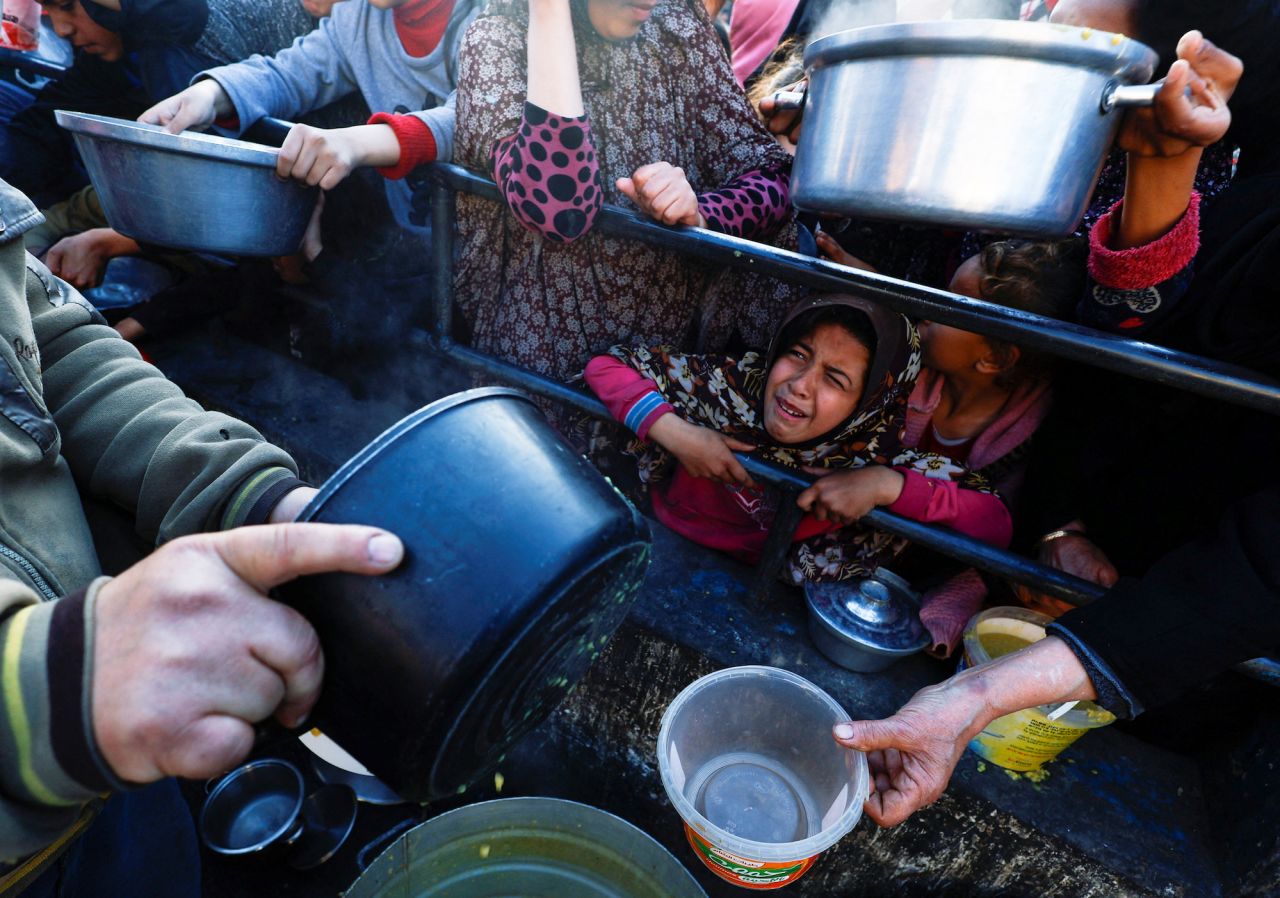 A child reacts as Palestinians wait to receive food in Rafah, southern Gaza on March 13.