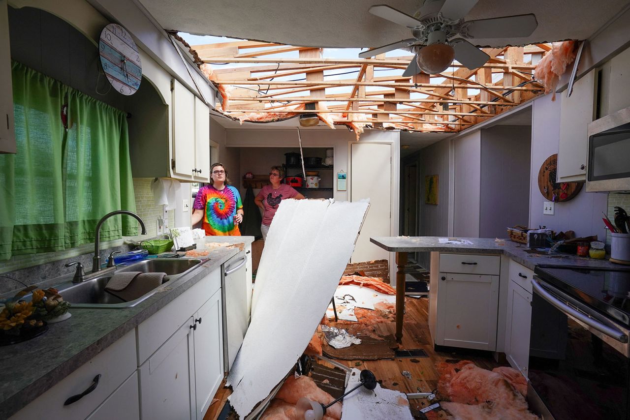 Andrea Barrios and her daughter Hannah survey the damage to her father's home in Charlotte Harbor on Thursday, September 29. 