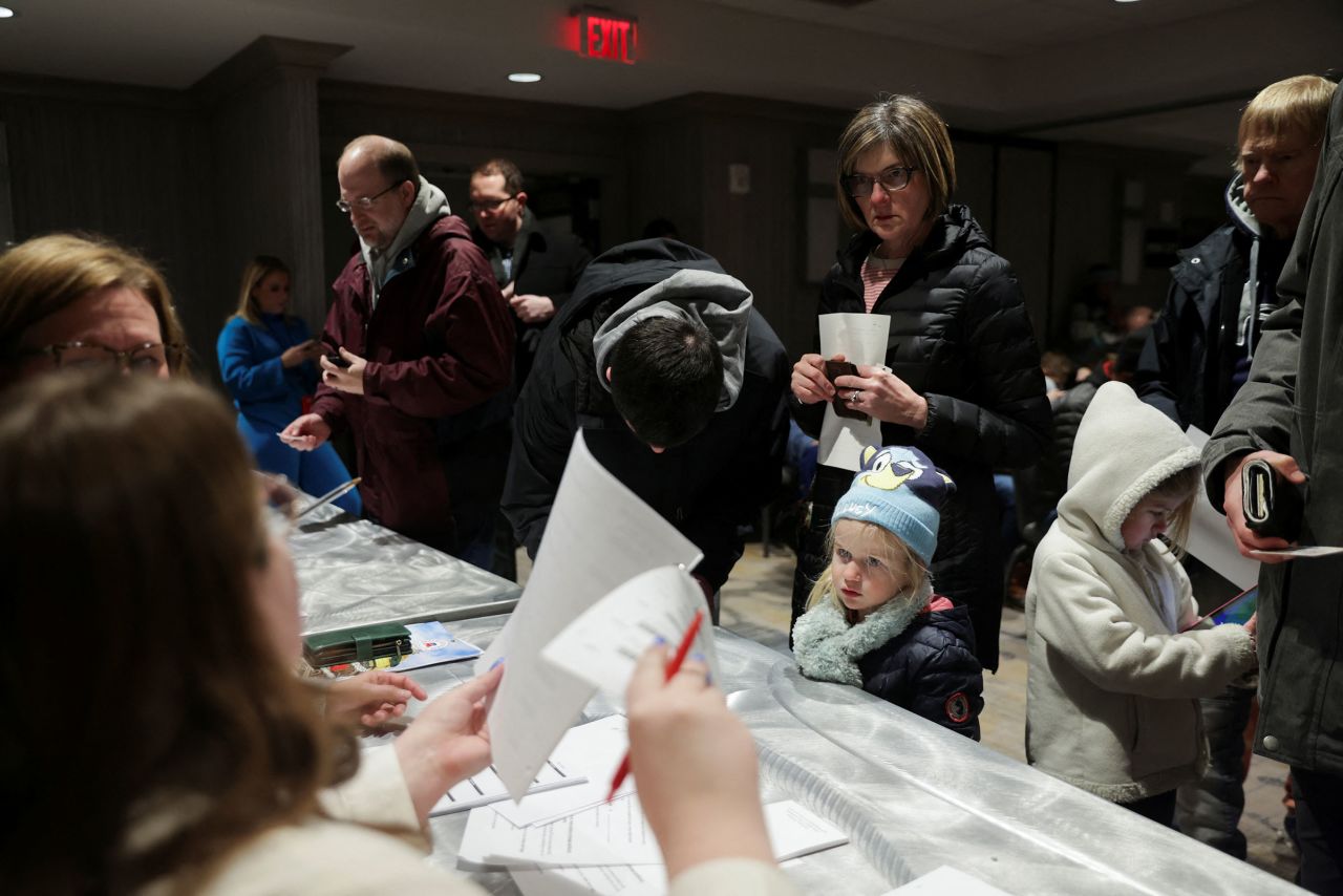 People participate on the day of the Republican presidential caucus in West Des Moines, Iowa, on Monday.