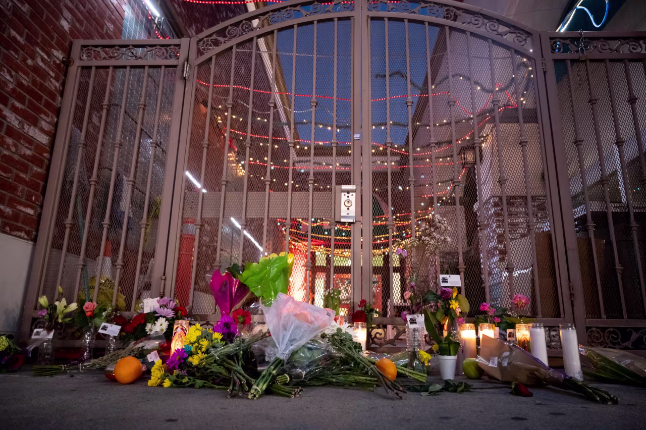 People leave flowers and candles at the Star Dance Studio in Monterey Park, California for the victims of the mass shooting on Monday.