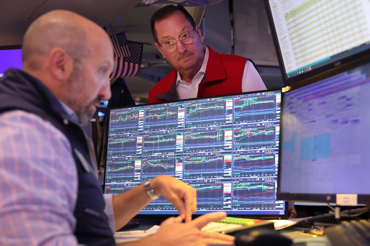 Traders work on the floor of the New York Stock Exchange during morning trading on August 6.