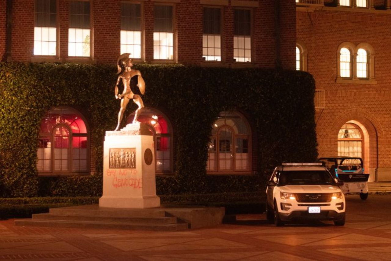 A USC Department of Public Safety vehicle sits next to the base of the Tommy Trojan statue that was tagged in Hahn Plaza at the University of Southern California, Los Angeles, on April 28, 2024.