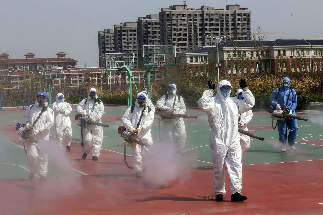 Volunteers spray disinfectant in the compounds of a school in Weifang, China, on April 12.