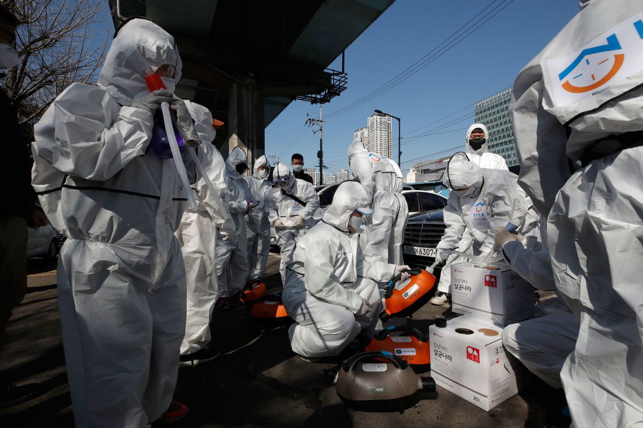 Workers prepare to spray disinfectant as a precaution against coronavirus in Seoul, South Korea on March 16. 