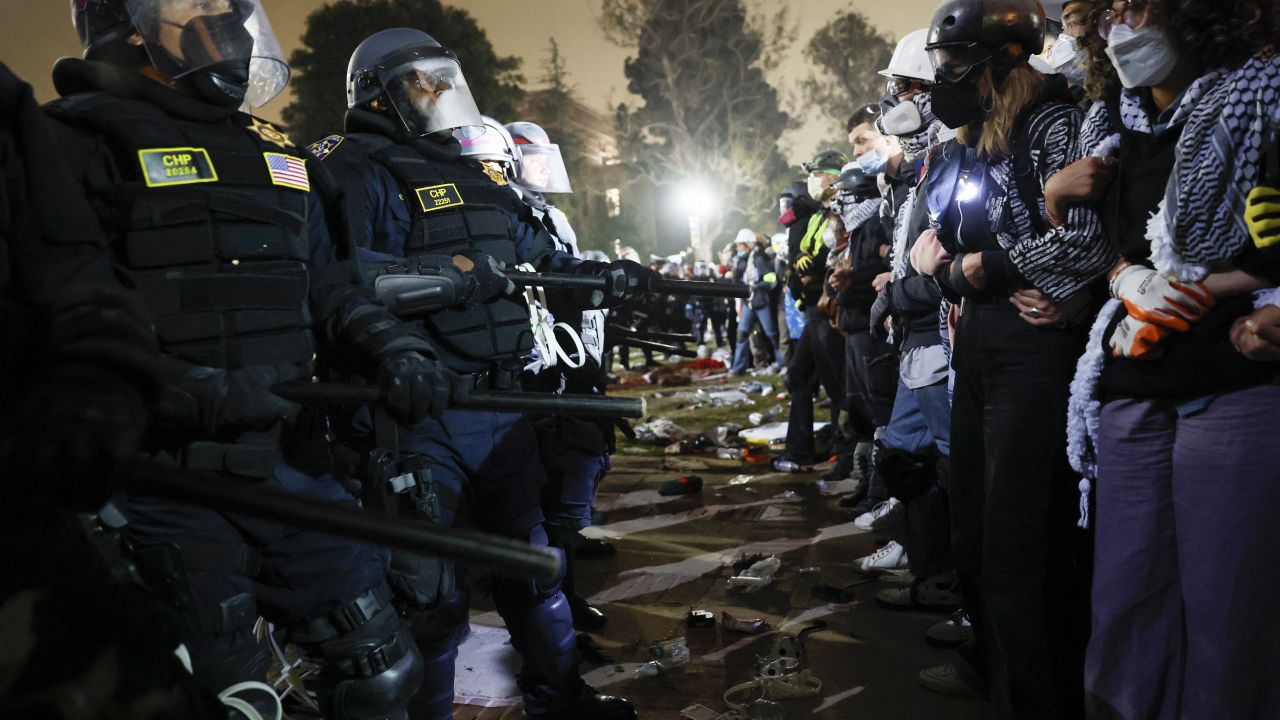 Police face off with pro-Palestinian protesters after destroying part of the encampment barricade on the UCLA campus early on Thursday, May 2.