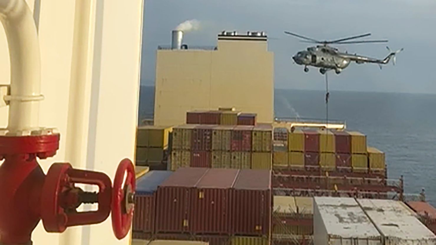 This image made from a video provided to The Associated Press by a Mideast defense official shows a helicopter raid targeting a vessel near the Strait of Hormuz on Saturday, April 13. 