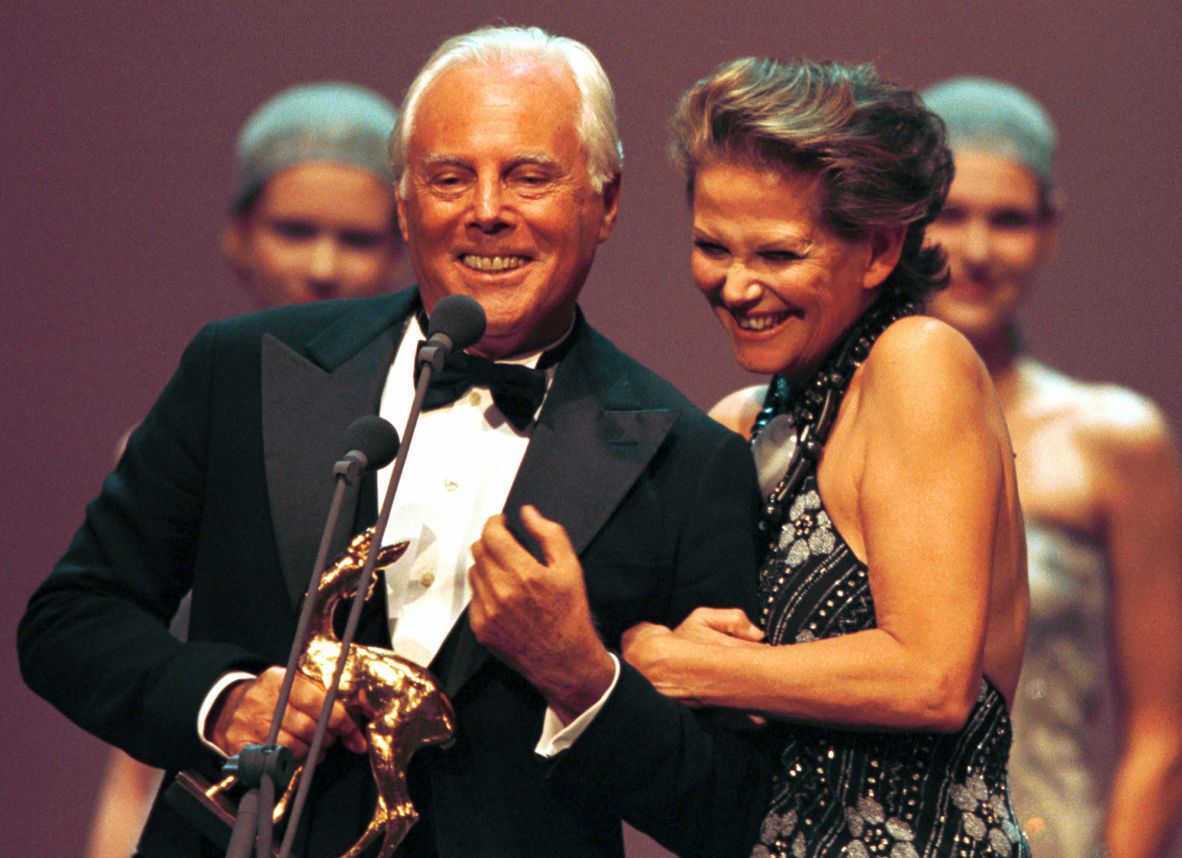 Italian actor Claudia Cardinale, right, congratulates Armani after he was honored with a BAMBI media award in Karlsruhe, Germany, in 1997.
