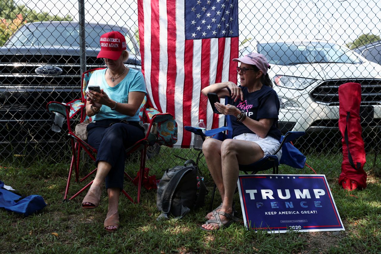 Supporters of former President Donald Trump sit near the entrance of the Fulton County Jail on Thursday.