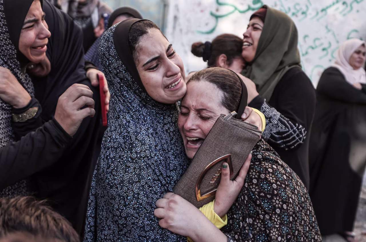 Relatives mourn for a family killed in an Israeli airstrike in Gaza City on October 21. 