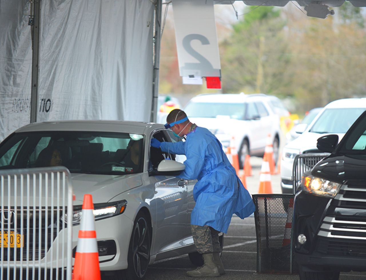 Medical professionals from the NYC Joint Task Force consisting of Army, Navy, Air Force and Marine Corps personnel administer COVID-19 tests at the drive-through testing center and field ER at Stony Brook, New York on on April 4. 