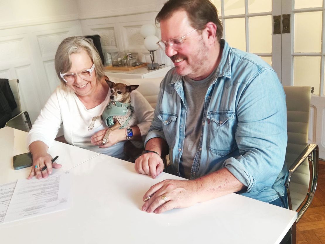 Pennie, Geoff and their dog, Coco, closing on their apartment in Nice in late 2023.